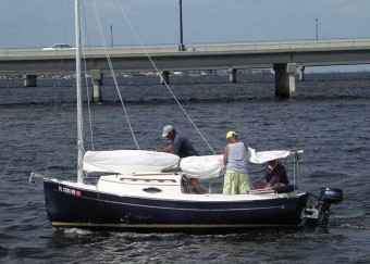 Flaking the sail on a Sun Cat - Photo of Com-Pac Sun Cat sail boat